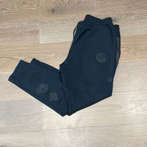 Nike sweatpants with cool patch work and zipper pockets .